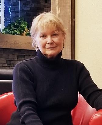 artist yvonne mcgrath seated in red chair